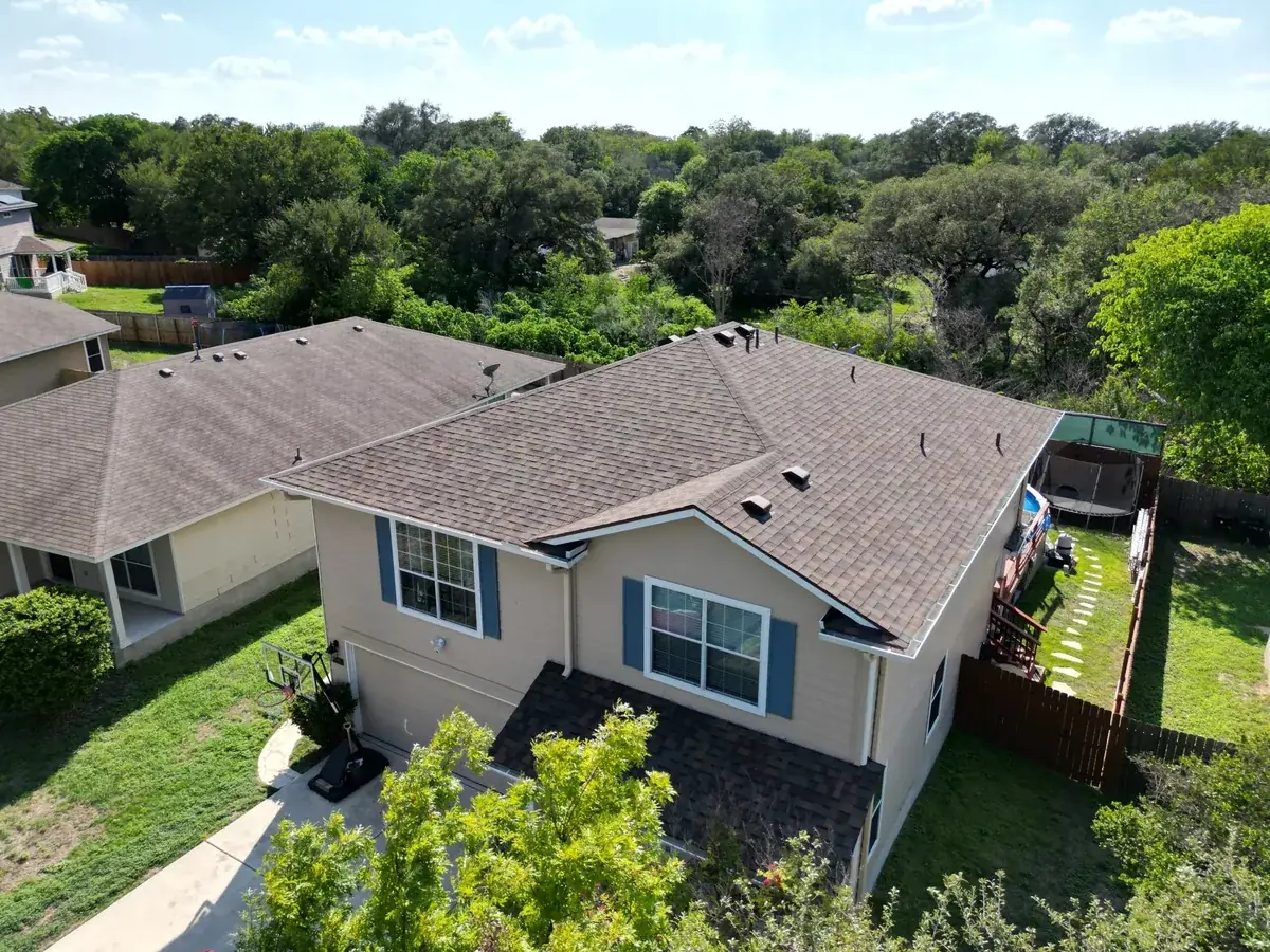 Alamo Roofing crew working on a residential roof